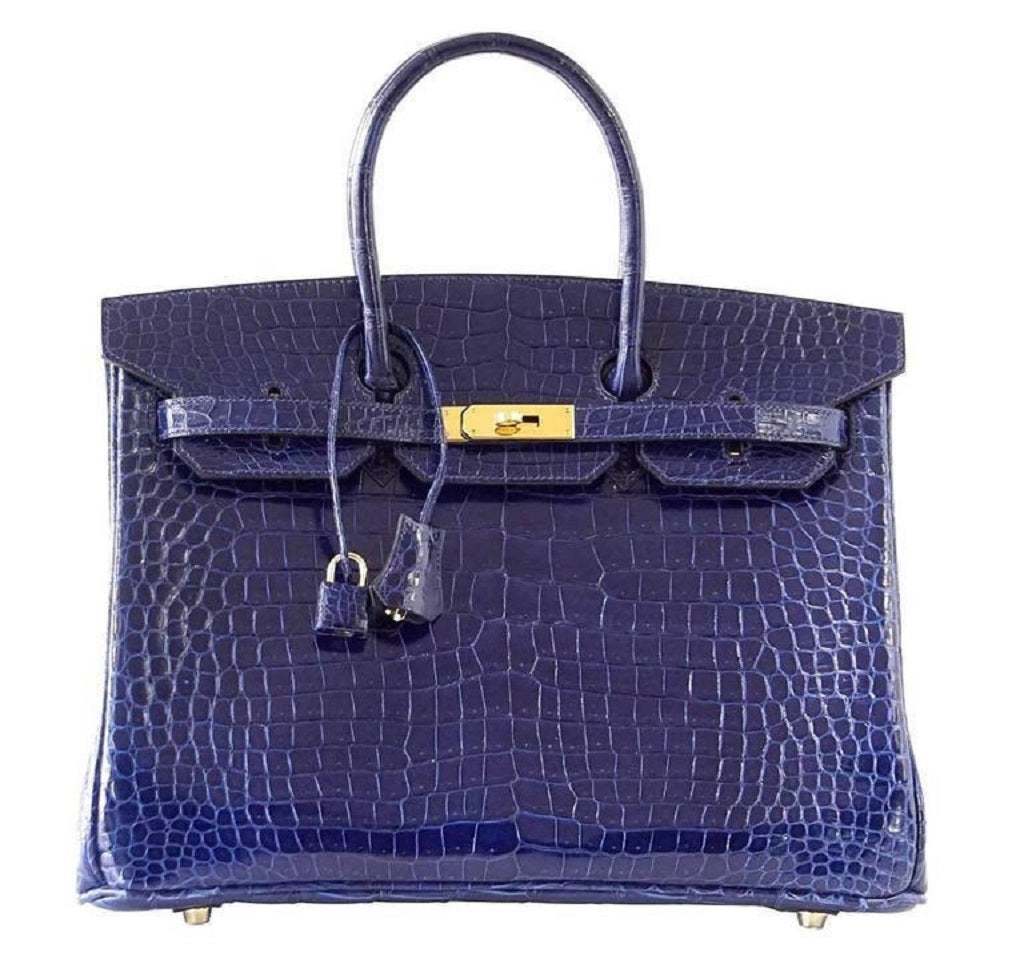 Blue alligator purse with gold buckle on a table on Craiyon